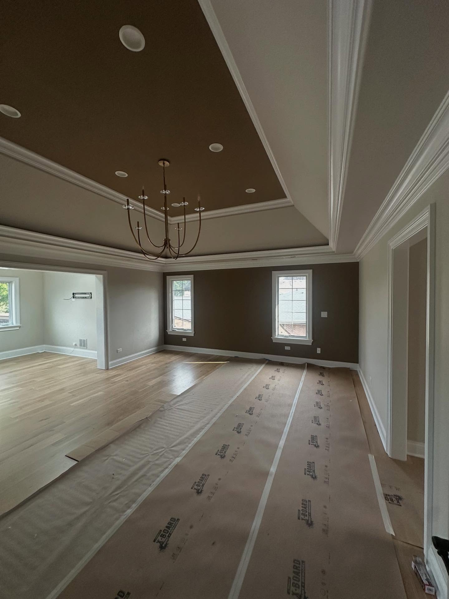 Finished room with dark painted tray ceiling and crisp wall lines