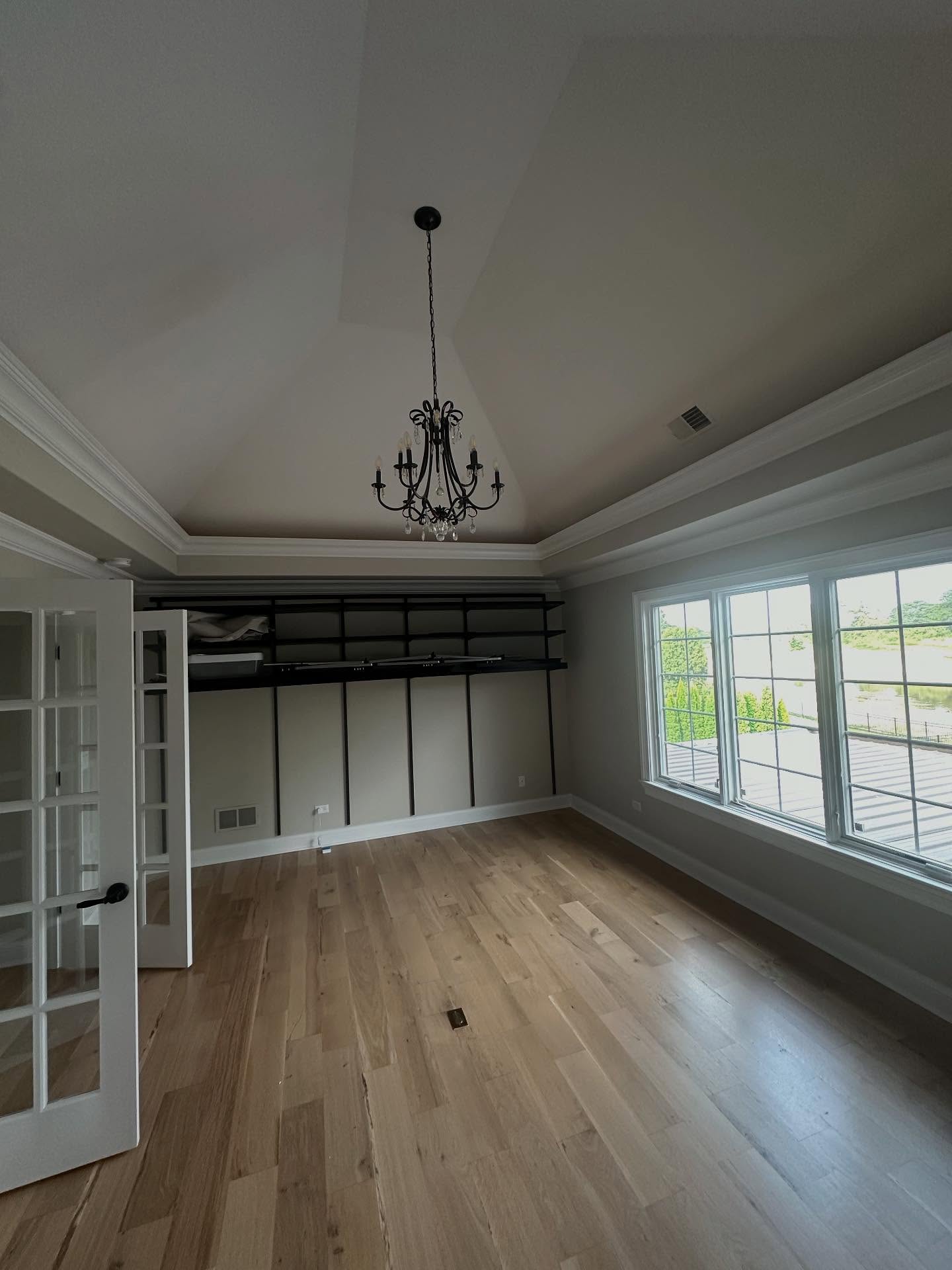 Vaulted bedroom with chandelier and built-in closet in Bloomingdale