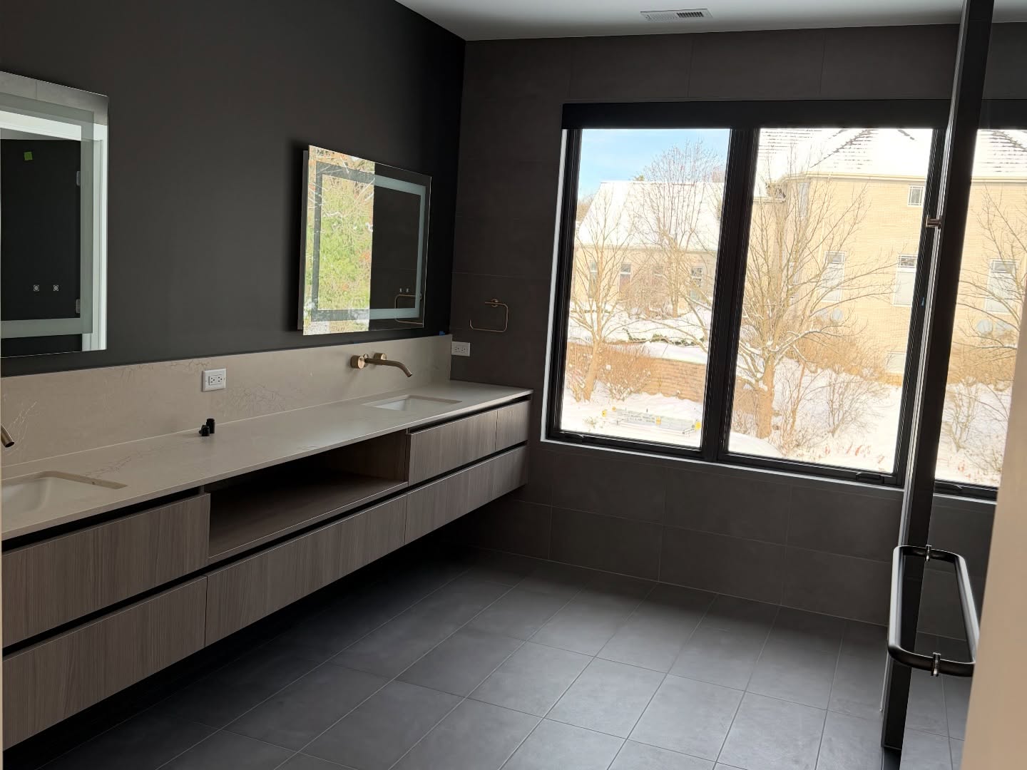 Luxury bathroom with dark walls and sauna glass enclosure