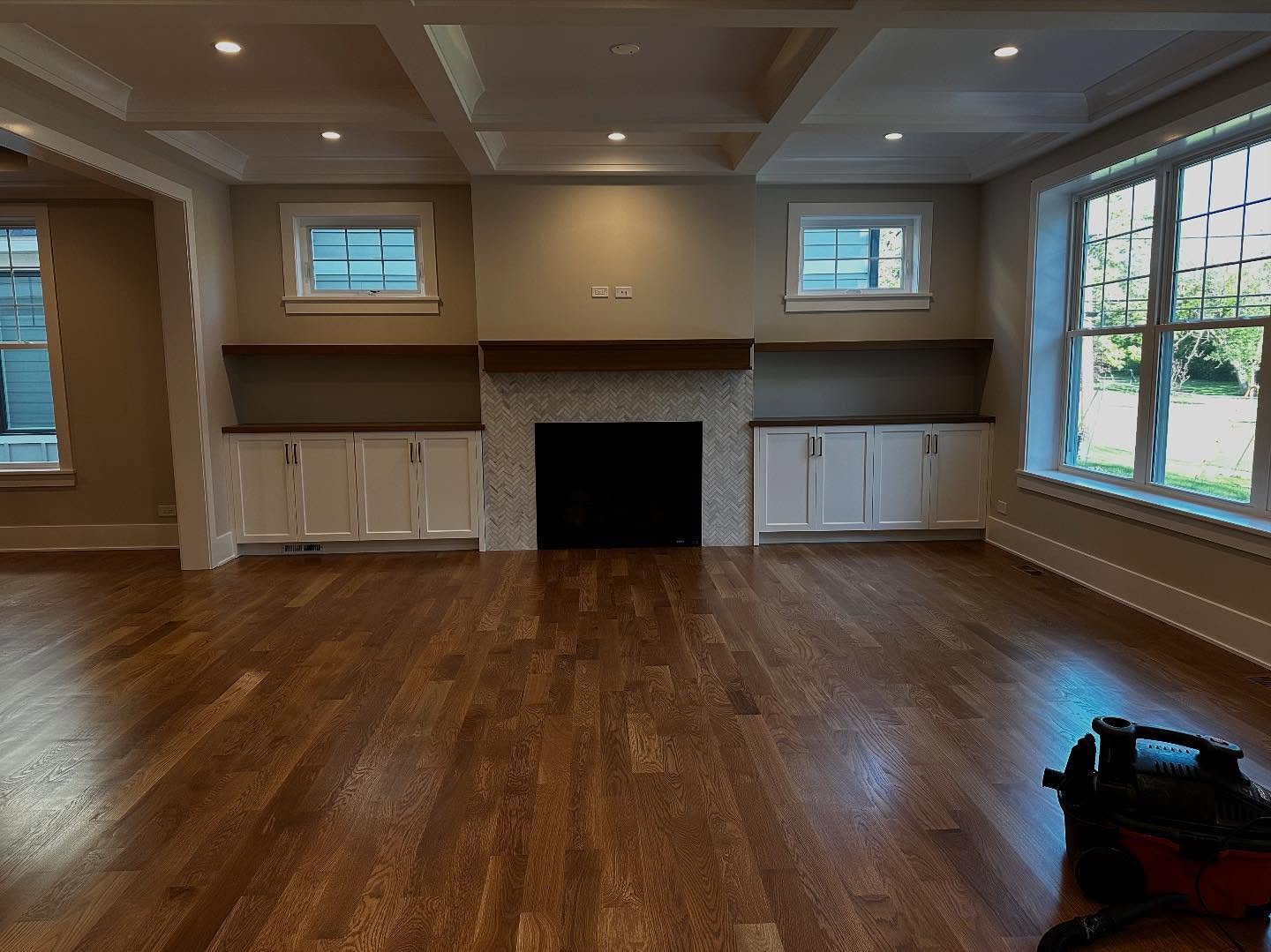 Living room with painted coffered ceiling and fireplace built-ins