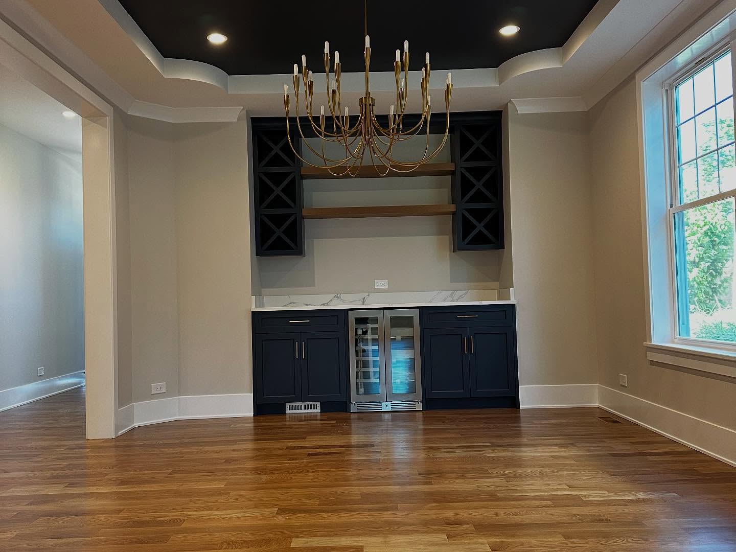 Dining area with dark painted accent ceiling and chandelier