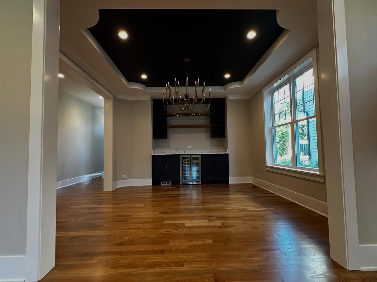 Elegant dining room with tray ceiling and chandelier in Elmhurst