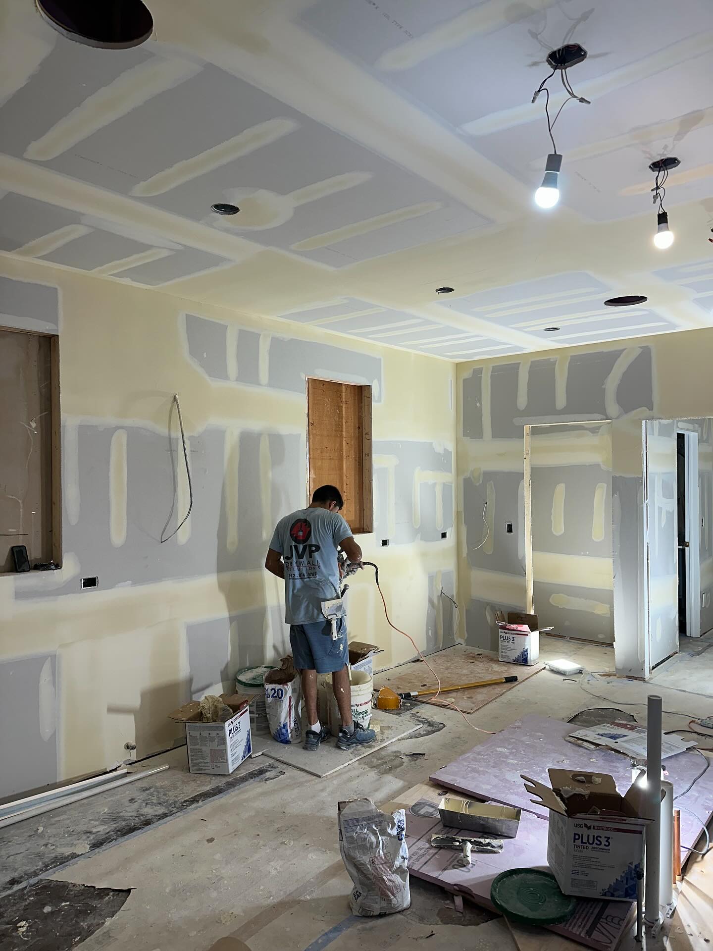 JVP worker applying second coat of joint compound
