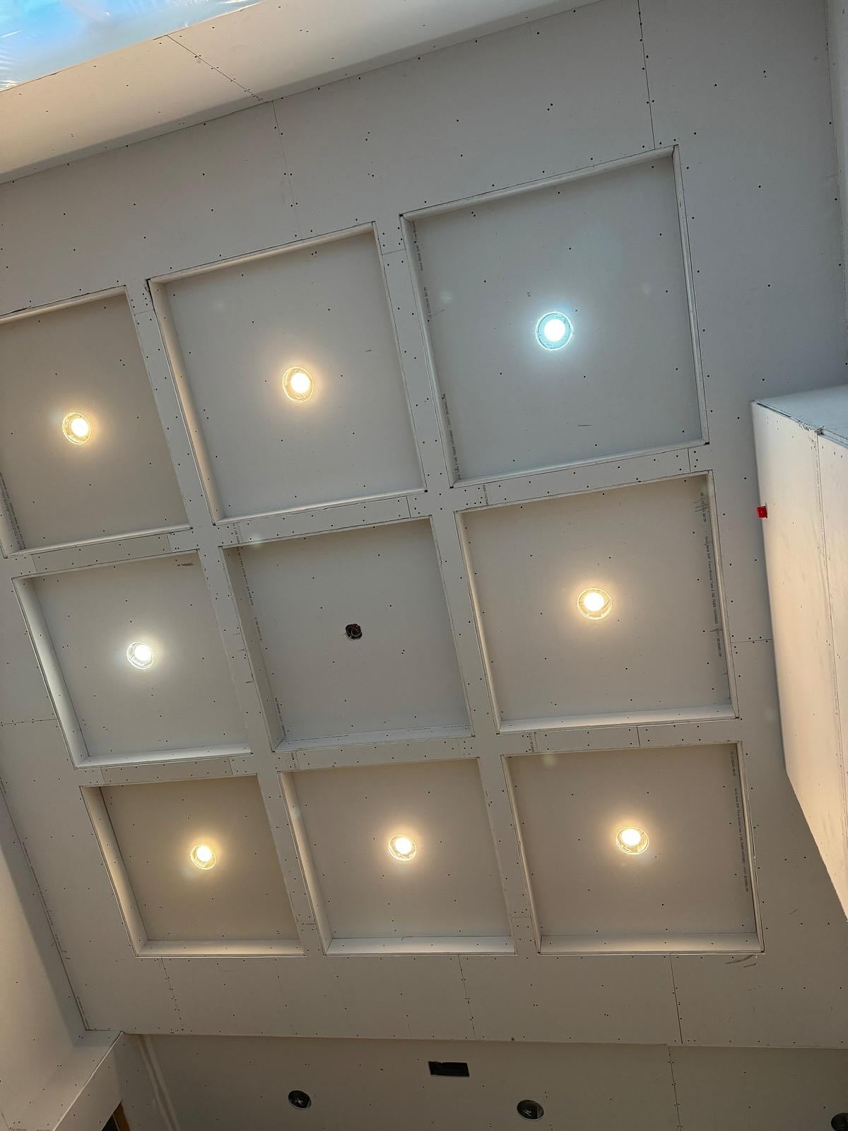 Drywall mud and tape applied to walls and ceiling in a new build