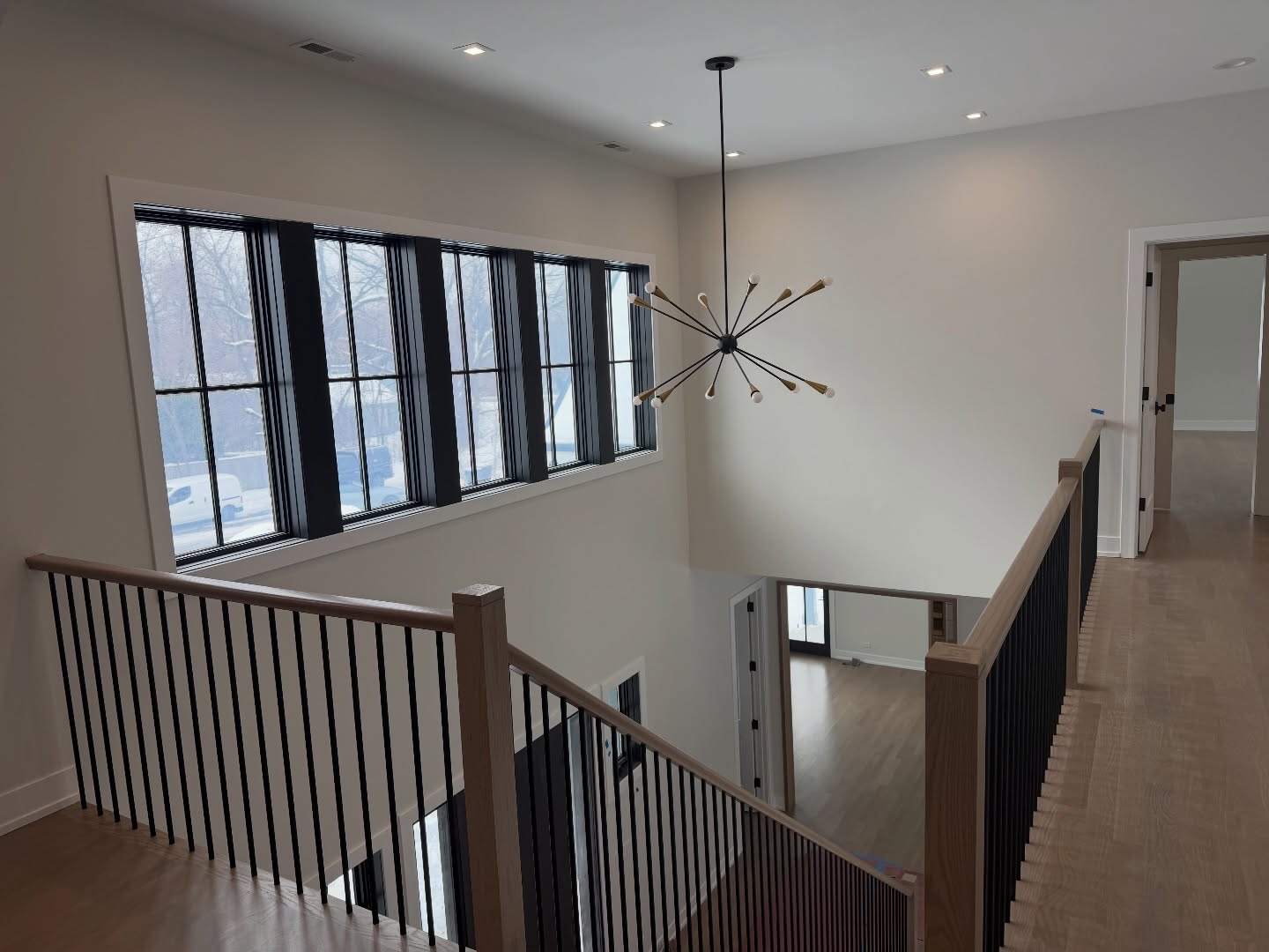 Modern staircase landing with sputnik chandelier in Northbrook