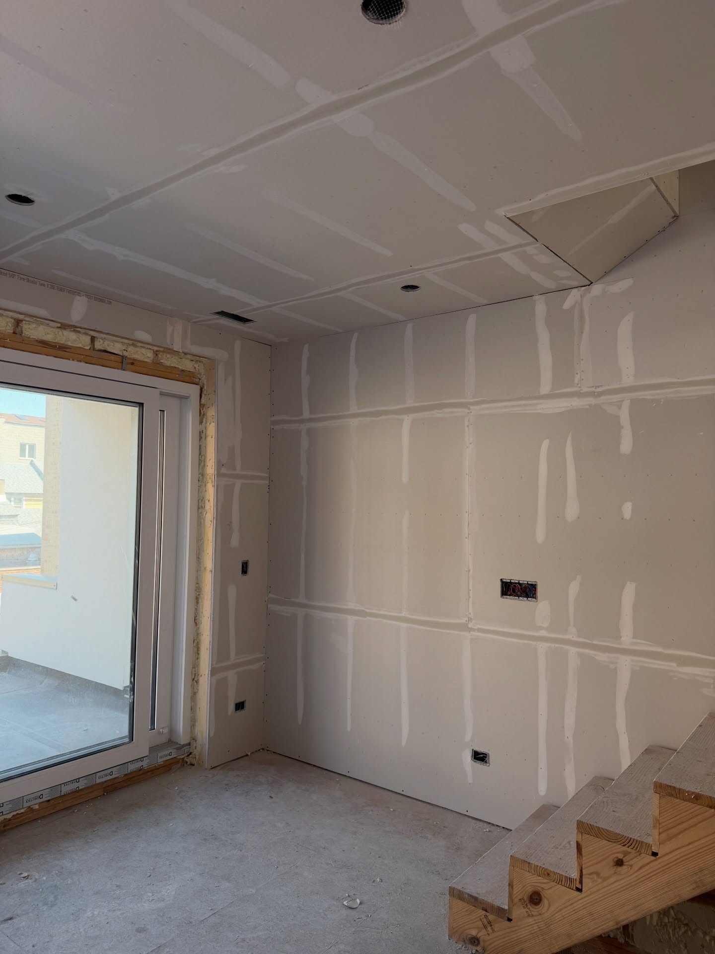 Room with pre-filled drywall seams ready for finish