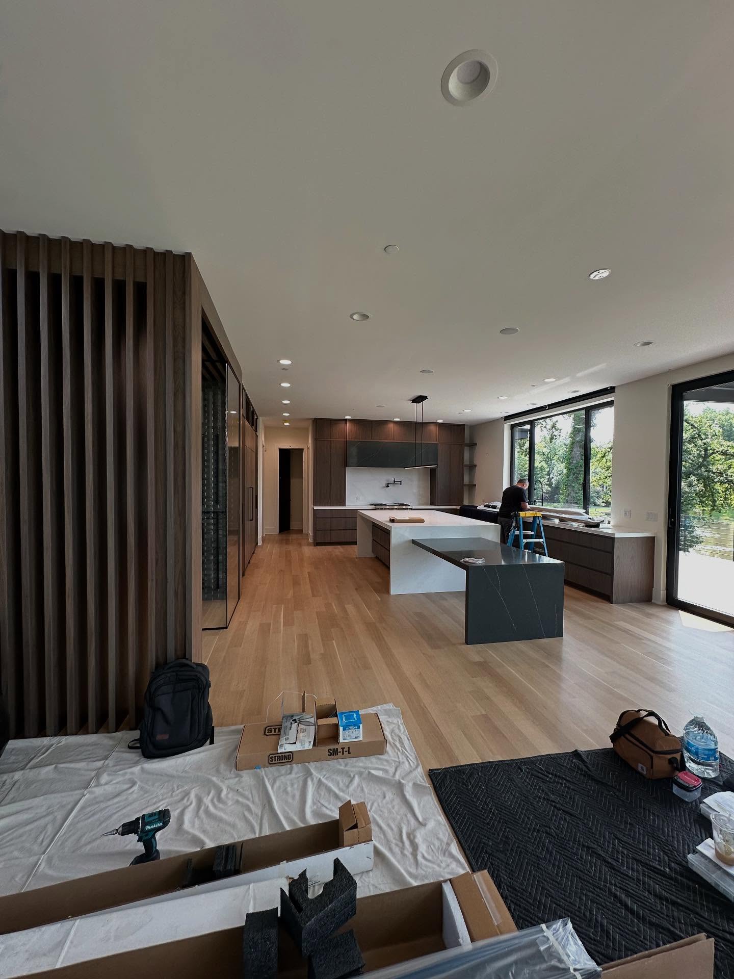 Large modern kitchen with island during commercial-scale build