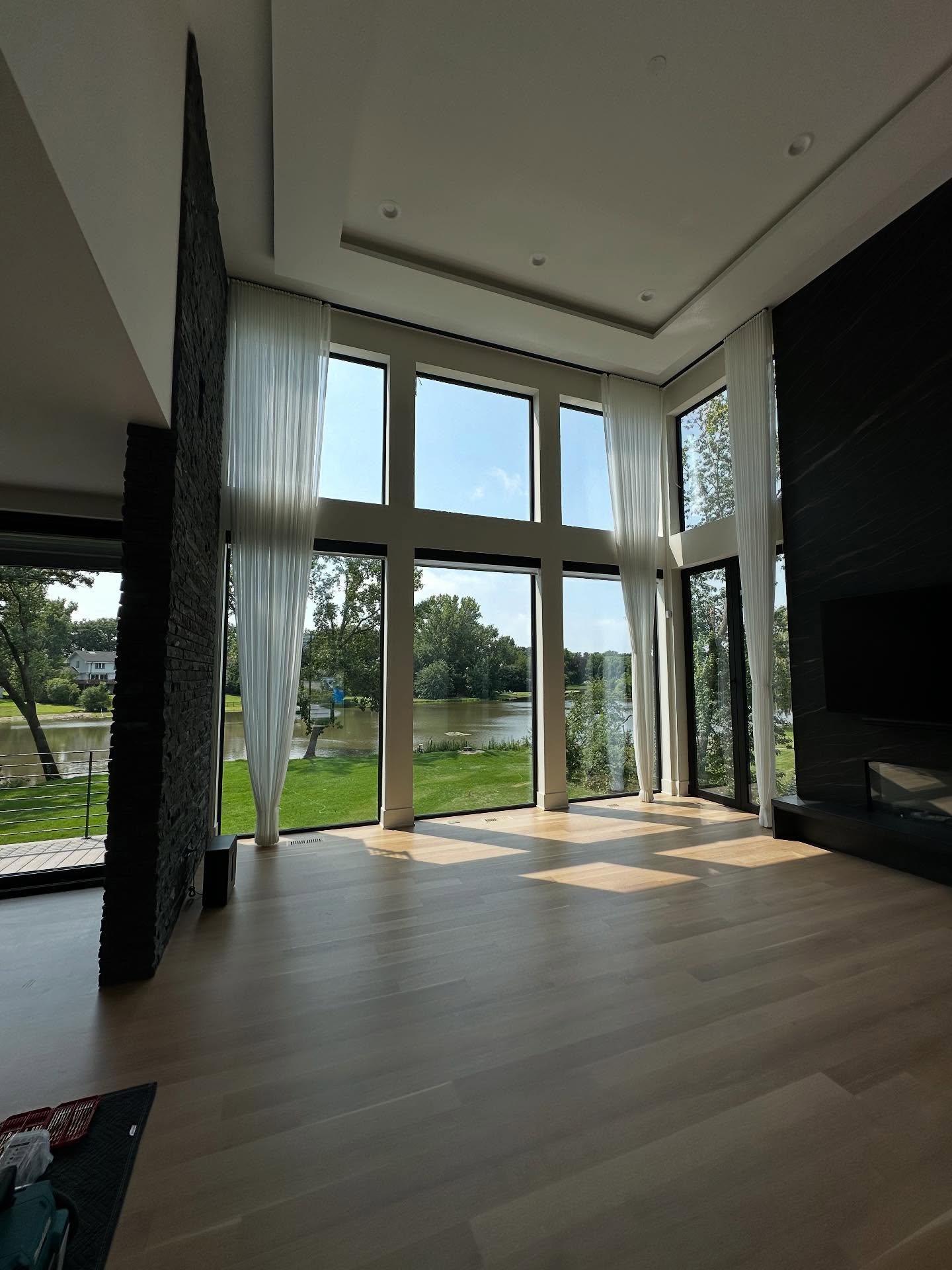 Completed luxury great room with double-height windows and lake view, Oak Brook