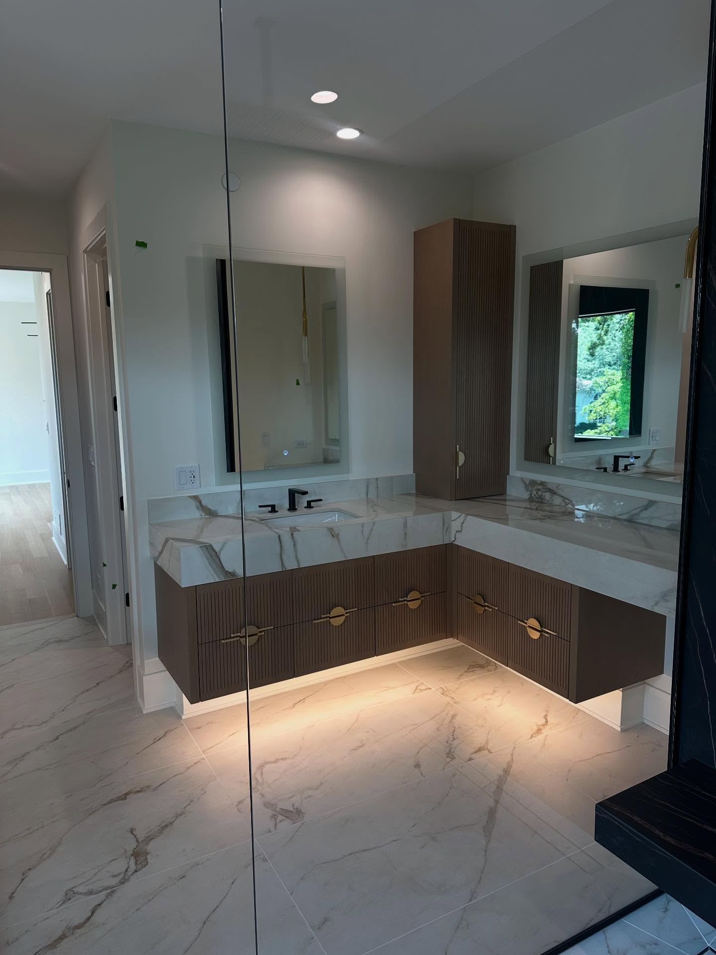 Luxury marble bathroom with floating vanity and gold hardware